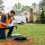 Technician performing spring septic system maintenance in a Georgia backyard